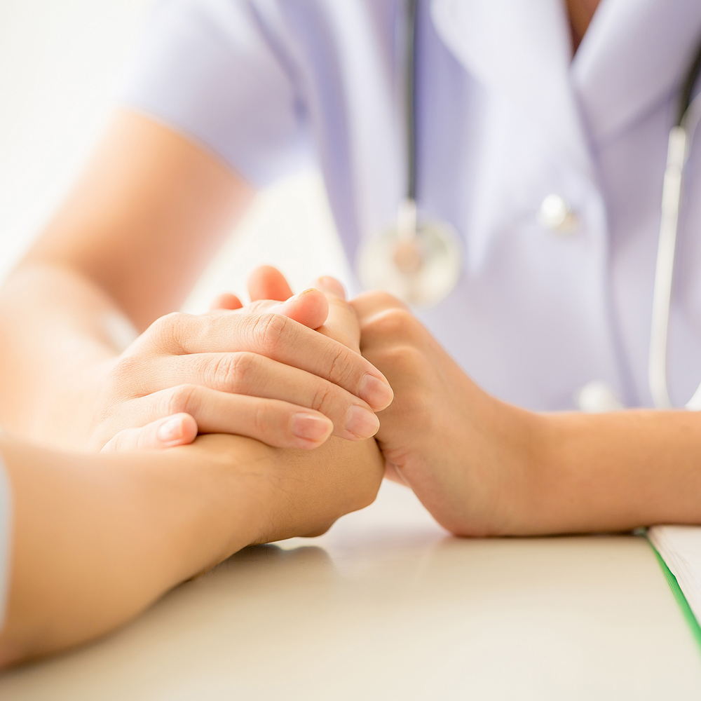 female psychologist consulting patient at the desk in hospital.